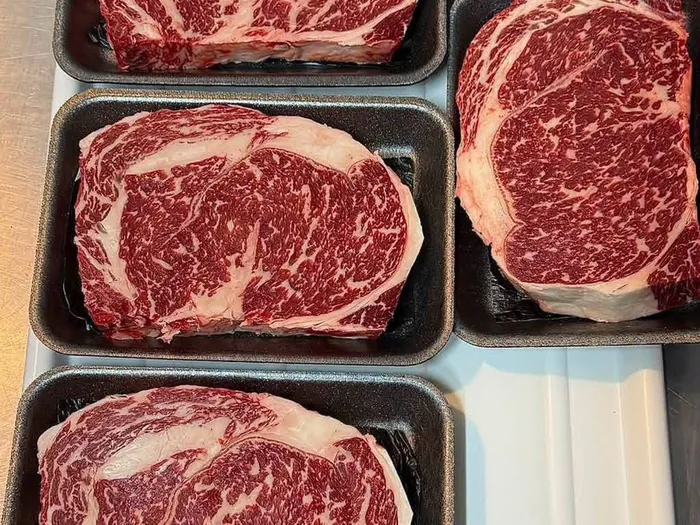 Vacuum packed ribeye steaks in trays